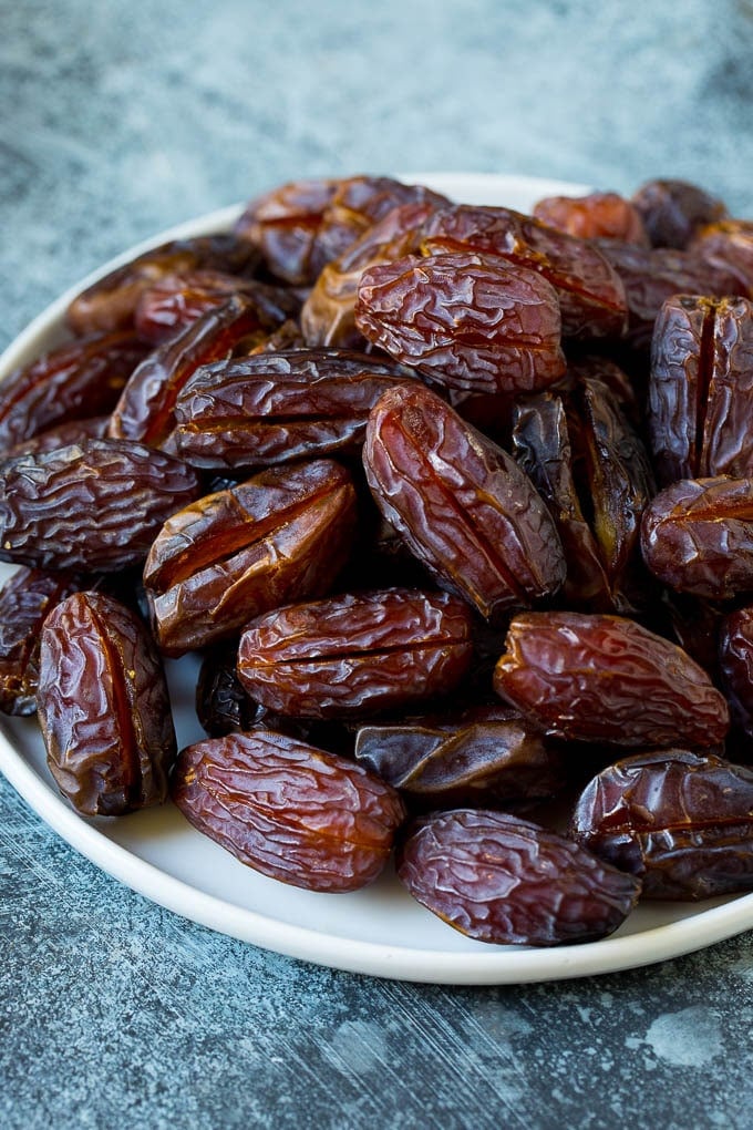 Bacon Wrapped Dates #appetizer #bacon #dates #cheese #sadud Dates split open on a plate.
