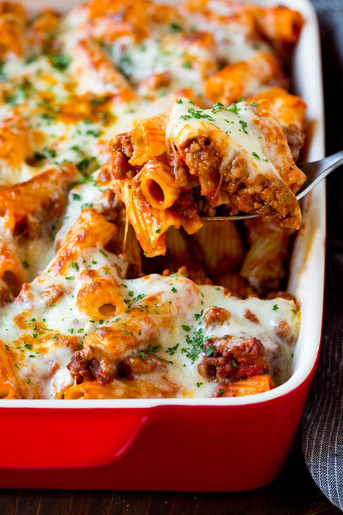 Baked Rigatoni Pasta #pasta #dinner #italianfood #groundbeef #sadud #casserole A spoon serving up a portion of baked rigatoni pasta.