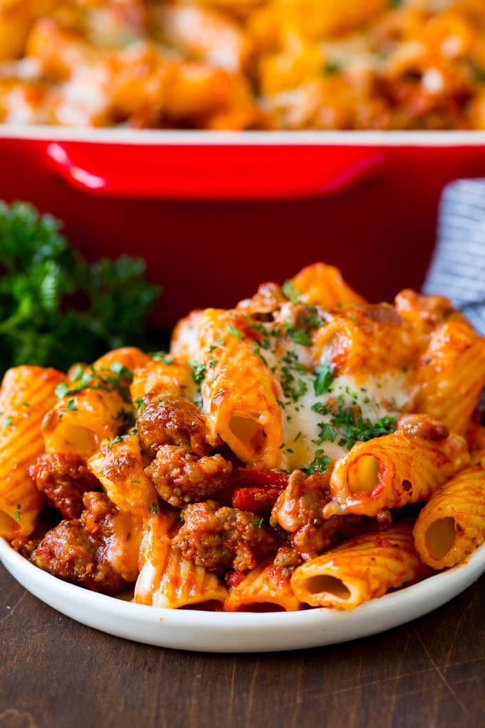 Baked Rigatoni Pasta #pasta #dinner #italianfood #groundbeef #sadud #casserole A plate of baked rigatoni topped with melted cheese.