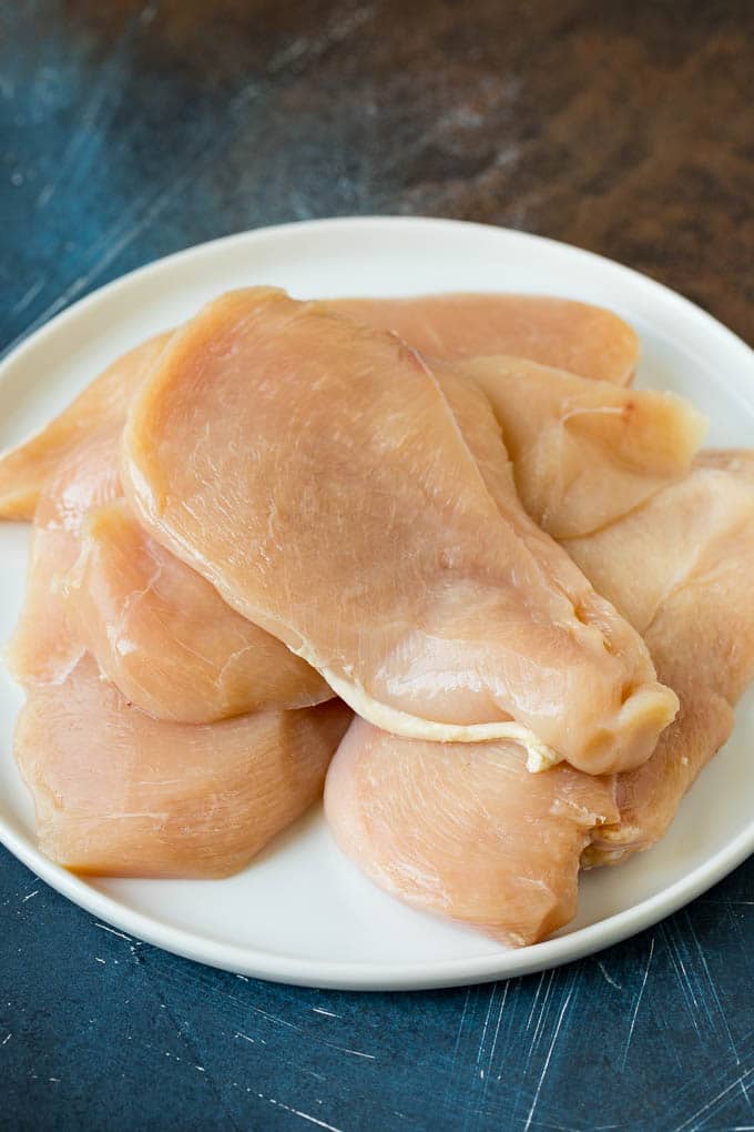 Chicken Francese Recipe #chicken #lemon #dinner #sadud Thin cut chicken breasts on a plate.