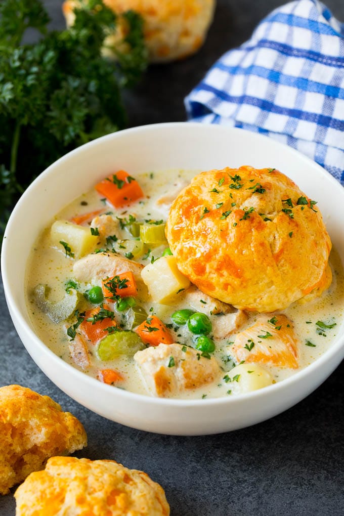 Chicken Pot Pie Soup Recipe | Chicken Soup #soup #chicken #dinner #comfortfood #sadud A bowl of chicken pot pie soup with a biscuit on top.