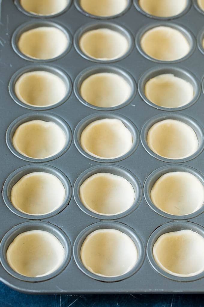 Mini Quiche Recipe #eggs #breakfast #brunch #appetizer #sadud Pie crust rounds pressed into muffin tins.