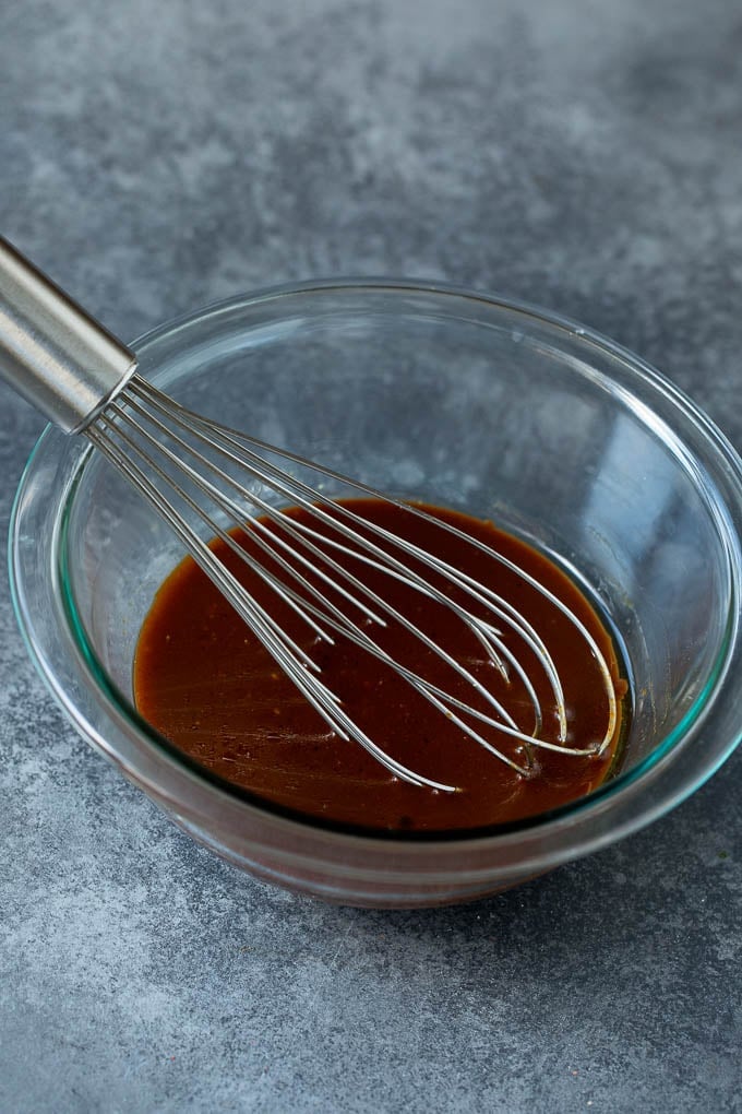 Asian Slaw Recipe #salad #slaw #sidedish #sadud A bowl of homemade sesame ginger dressing.