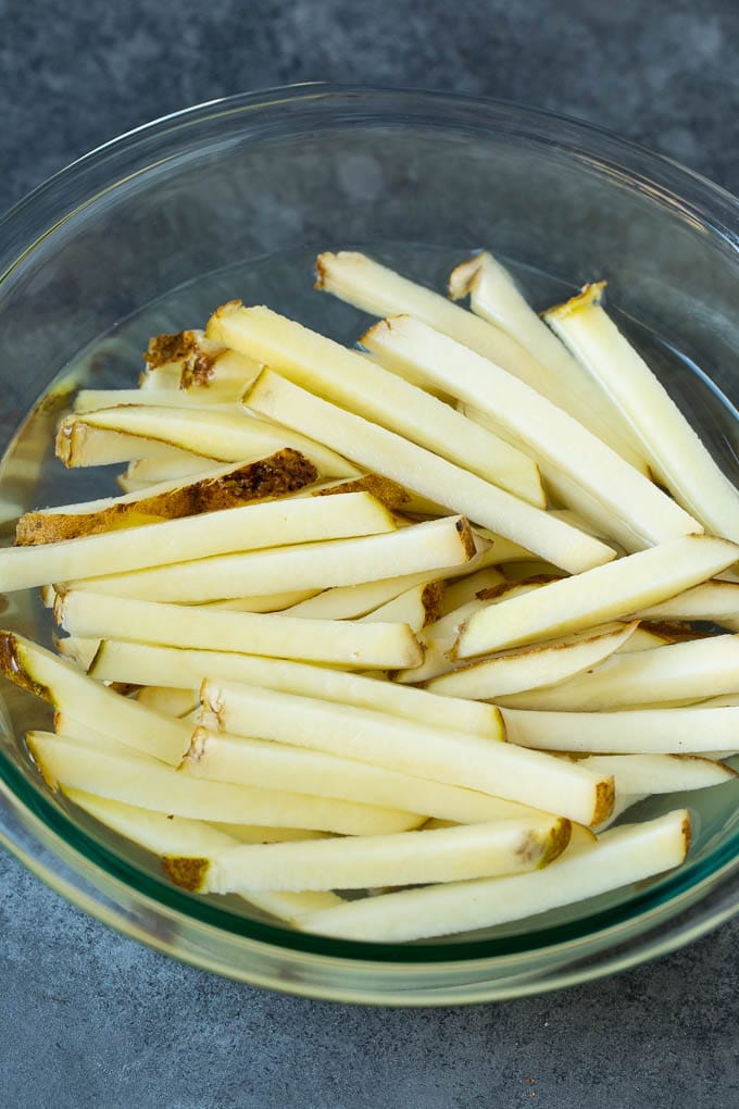 Homemade French Fries Recipe #potatoes #fries #dinner #sadud Sliced potato sticks in a bowl of water.
