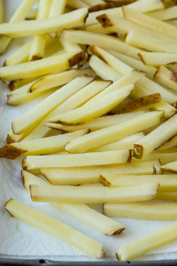 Homemade French Fries Recipe #potatoes #fries #dinner #sadud Potatoes cut into fry shapes on a paper towel lined pan.
