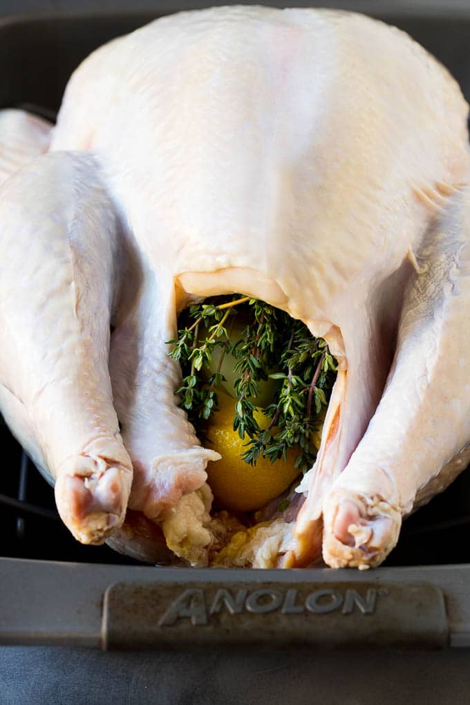 This is a complete guide on how to cook a turkey. A turkey with the cavity stuffed with lemon and herbs.