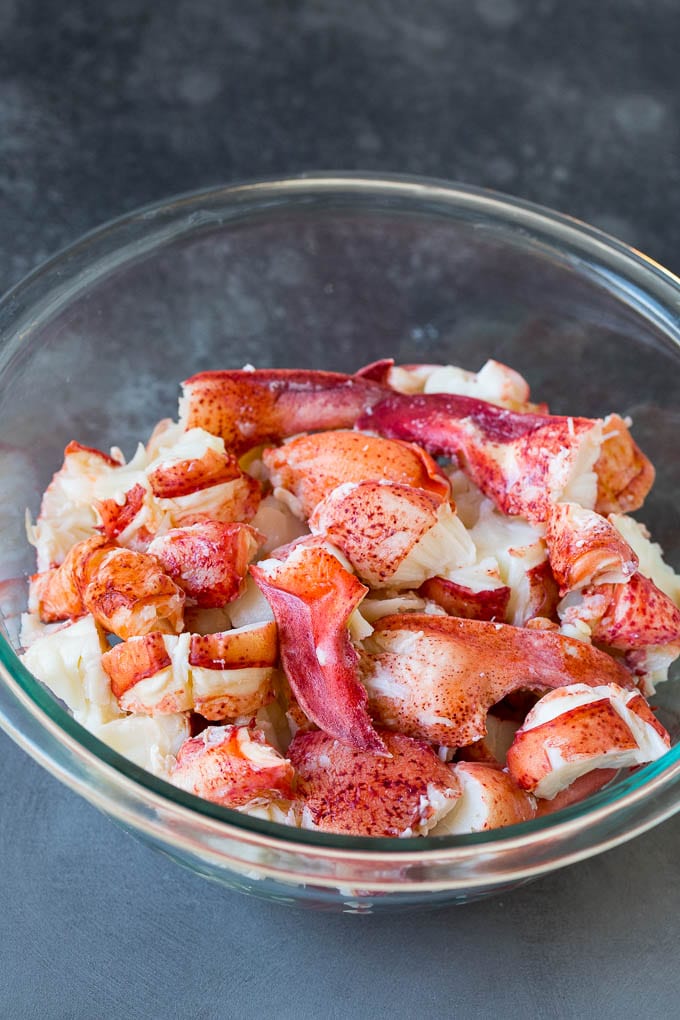 Lobster rolls stuffed with creamy lobster salad in a toasted bun. #lobster #sadud Chunks of lobster meat in a bowl.