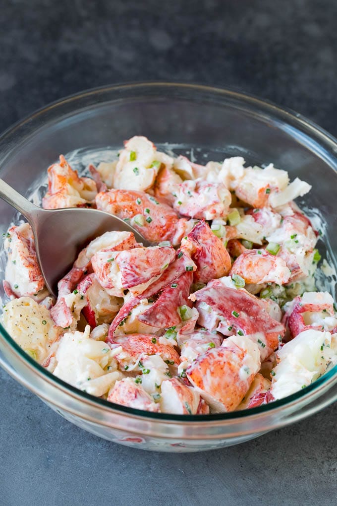 Lobster rolls stuffed with creamy lobster salad in a toasted bun. #lobster #sadud Lobster salad in a bowl in a creamy dressing.