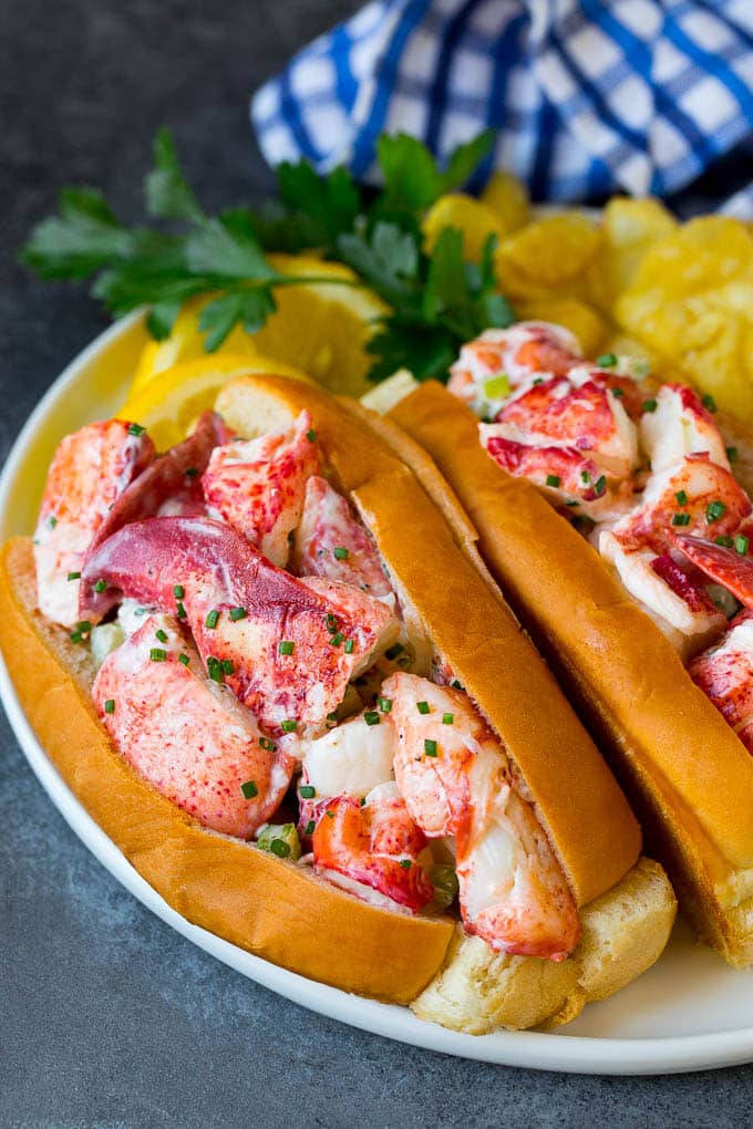 Lobster rolls stuffed with creamy lobster salad in a toasted bun. #lobster #sadud Lobster roll with chunks of fresh lobster meat in a buttered and toasted bun.