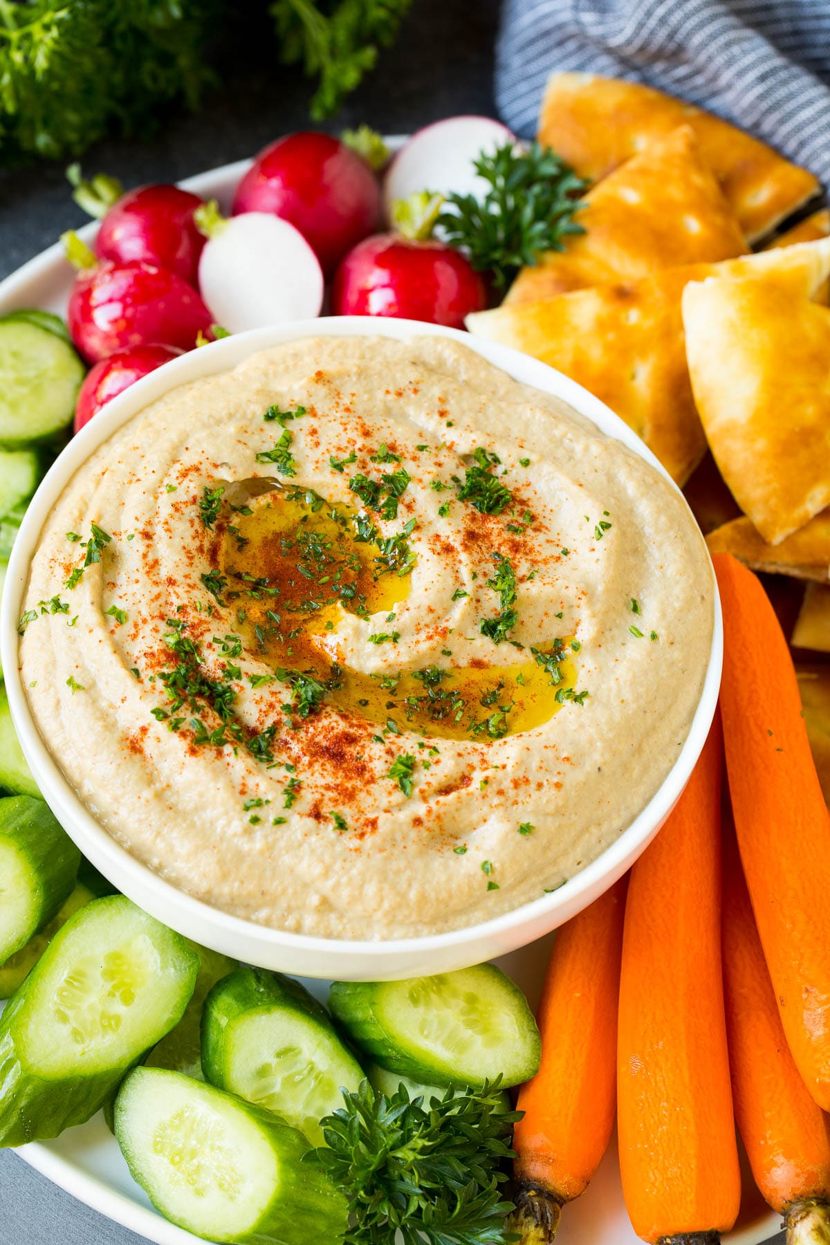 Baba Ganoush Recipe | Eggplant Dip #eggplant #appetizer #dip #healthy #glutenfree #lowcarb #sadud Baba ganoush in a bowl surrounded by bread and vegetables.
