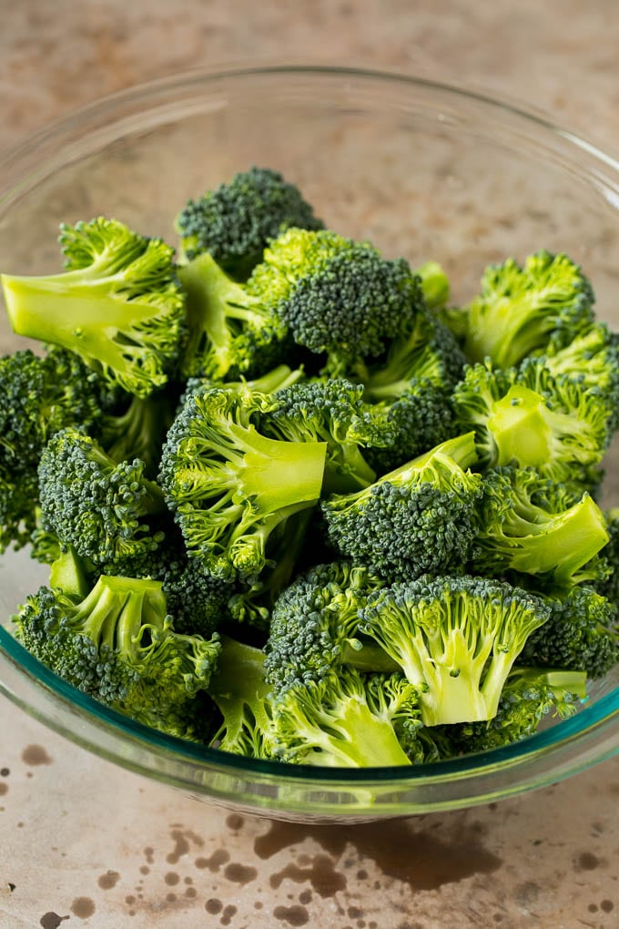 Grilled broccoli is packed with flavor and is a colorful and healthy side dish! #broccoli #sadud Green florets in a bowl.