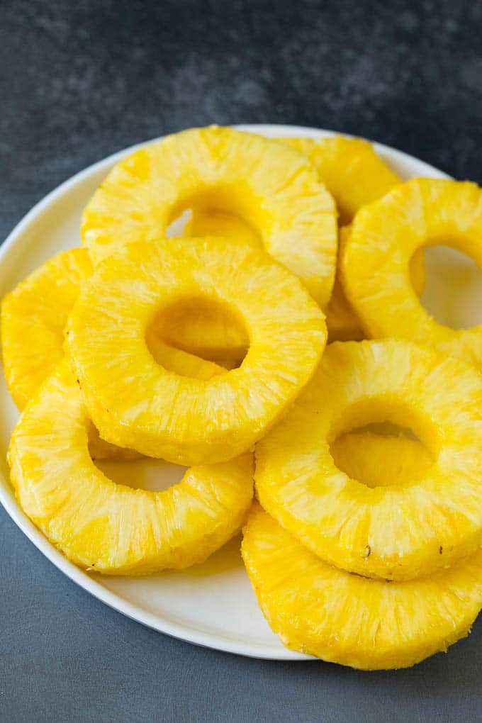 Brown sugar grilled pineapple is a quick and easy side dish or dessert! Slices of fruit on a plate.
