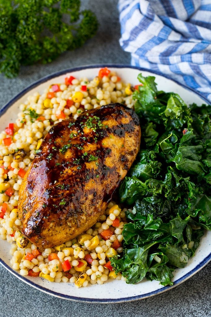 Sauteed kale flavored with olive oil and garlic, a quick and easy side dish! #kale #sadud Grilled chicken served with a side of sauteed kale.