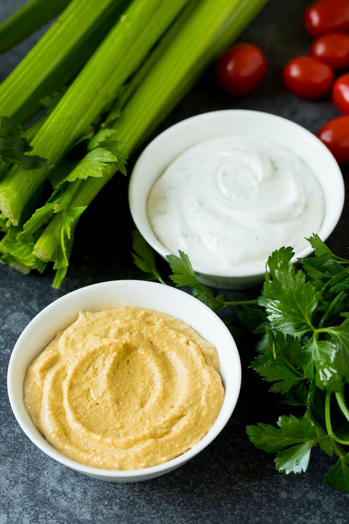 This homemade veggie tray is an assortment of colorful vegetables paired with a variety of flavorful dips. Bowls of hummus and ranch dip.