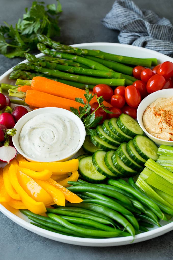 This homemade veggie tray is an assortment of colorful vegetables paired with a variety of flavorful dips. A veggie tray filled with fresh vegetables and two types of dip.