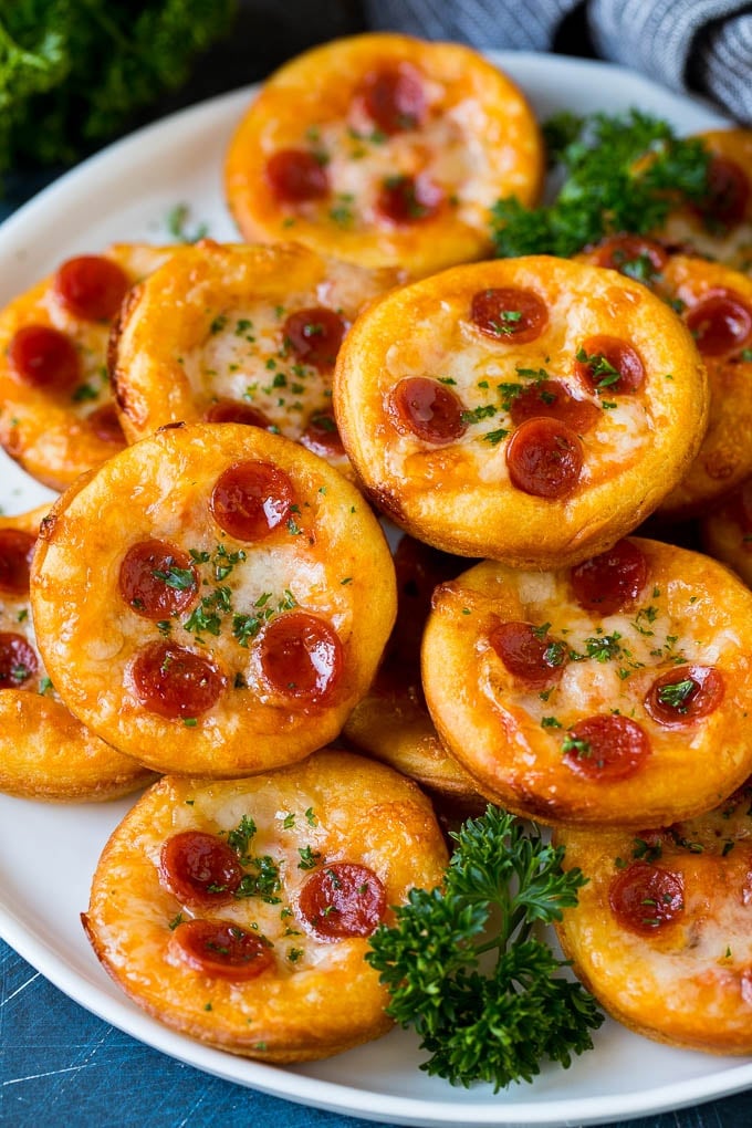 Mini pizzas topped with pepperoni are a fun and easy appetizer option. #pizza #sadud #appetizer Mini pizzas topped with melted cheese and pepperoni.