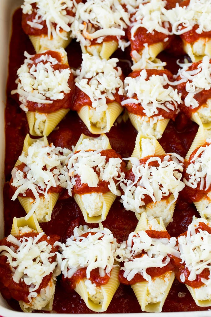 Baked stuffed shells filled with three types of cheese and topped with marinara sauce. #pasta #sadud Filled pasta topped with marinara sauce and shredded cheese.