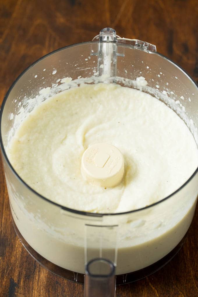 These cauliflower mashed potatoes are mixed with butter, cream and seasonings to make a super delicious side dish that's low in carbohydrates. Cauliflower pureed in a food processor.