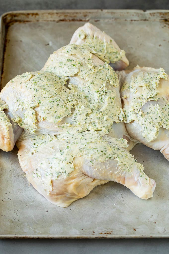 This spatchcock chicken is tender, juicy and cooks quickly, the perfect easy dinner! A flattened chicken coated in garlic and herb butter.