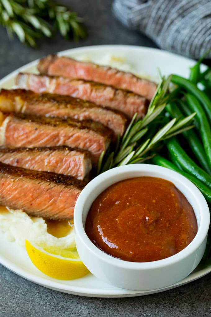Homemade steak sauce is a savory blend that takes just 5 minutes to make and goes perfectly with beef, chicken and pork. Homemade steak sauce served with sliced steak and green beans.