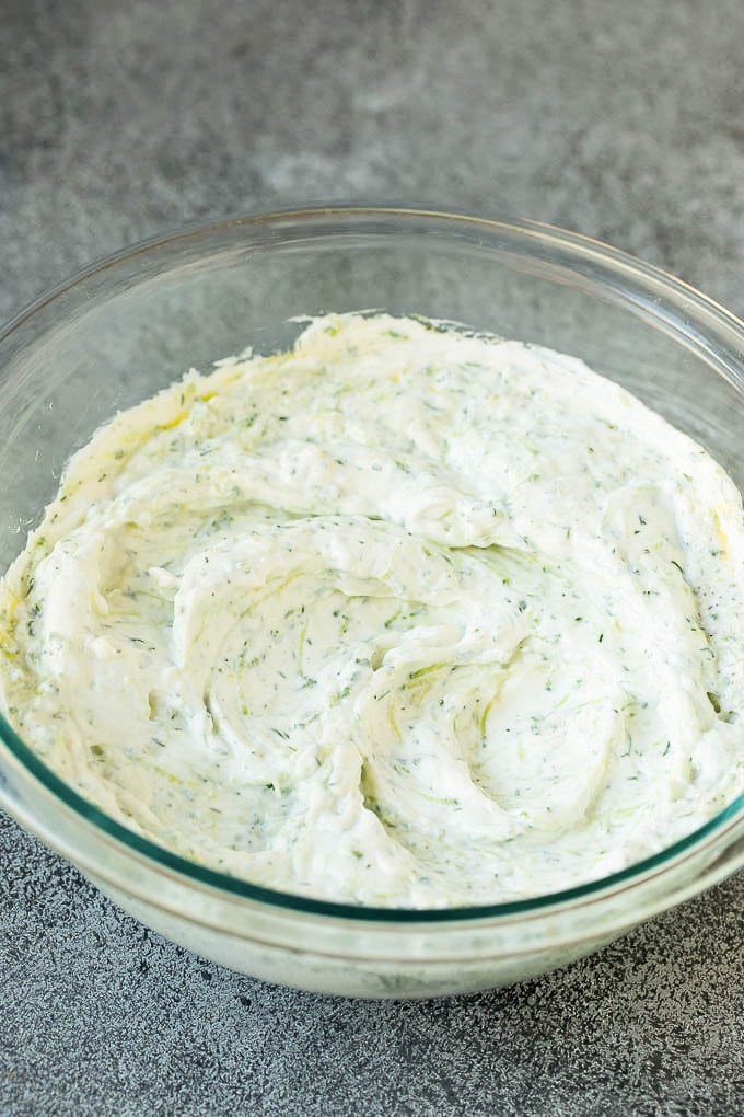 The best homemade tzatziki sauce with cucumber and herbs mixed into Greek yogurt. #appetizer #sadud Tzatziki sauce in a glass bowl.
