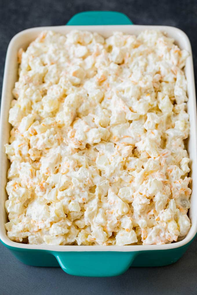 These cheesy potatoes are diced potatoes tossed in a creamy blend of sour cream, butter and cheese, then baked to golden brown perfection. Creamy potatoes in a baking dish.