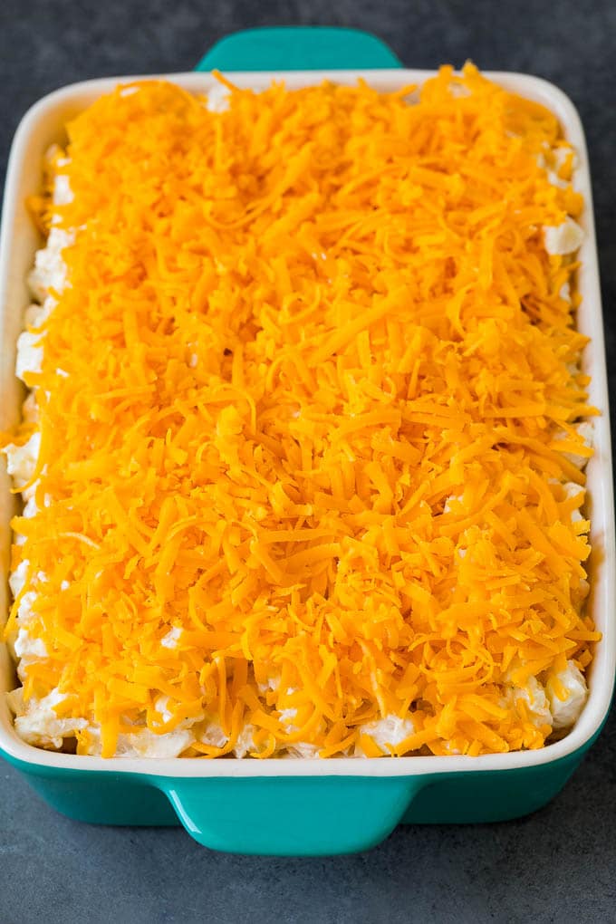 These cheesy potatoes are diced potatoes tossed in a creamy blend of sour cream, butter and cheese, then baked to golden brown perfection. Creamy potatoes topped with shredded cheddar cheese.