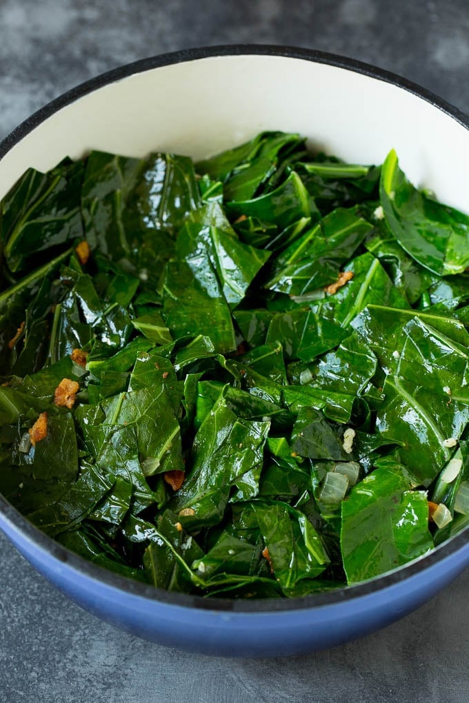 These Southern style collard greens are simmered with bacon and seasonings until tender and flavorful. Cooked leaves with bacon.