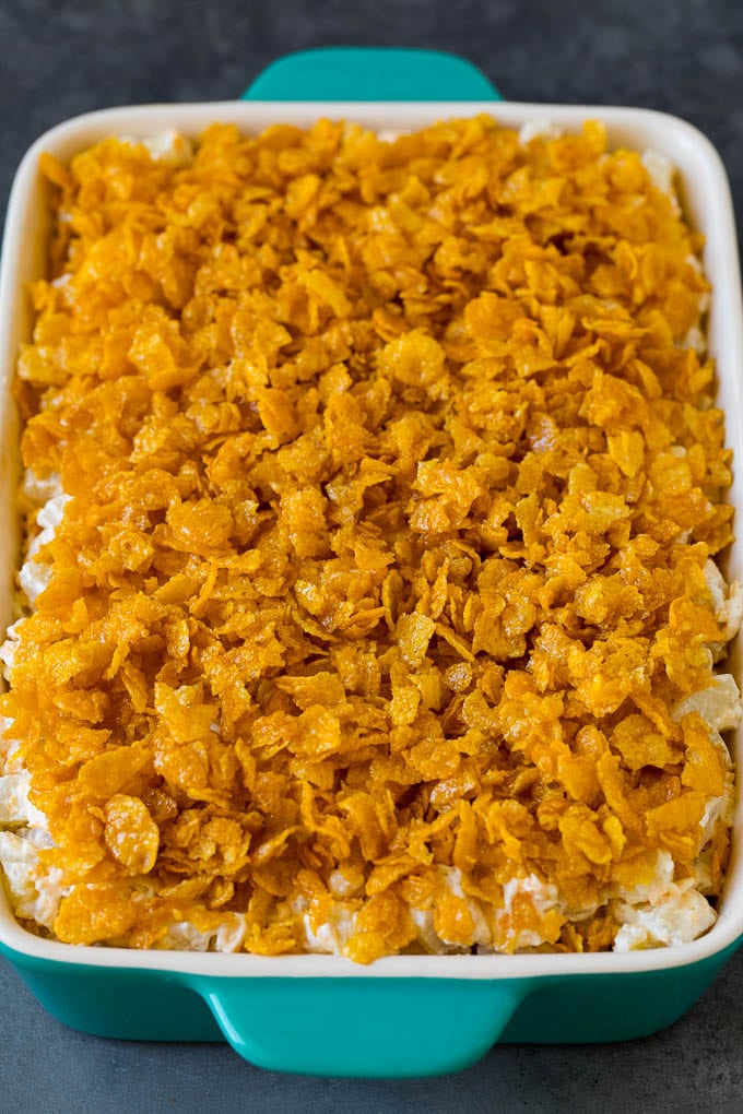 Funeral potatoes are creamy and cheesy potatoes that are topped with buttered cornflakes and baked to golden brown perfection. A dish of cheesy potatoes topped with cornflakes.