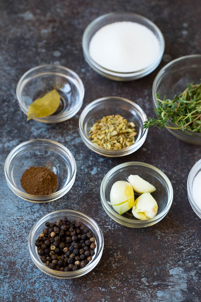 This pork chop brine is a blend of salt, sugar, herbs and spices that infuses the meat with flavor and helps to keep it tender and juicy. Bowls of spices, salt, sugar and herbs.