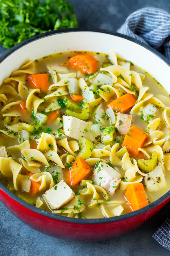 This turkey soup recipe is homemade turkey broth loaded with vegetables, diced turkey and egg noodles. Turkey soup with egg noodles and colorful vegetables in a pot.