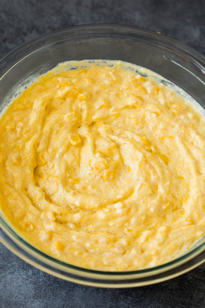 This corn souffle recipe is a flavorful blend of corn kernels, butter, eggs and creamed corn, all baked to light and fluffy perfection. Batter in a mixing bowl.