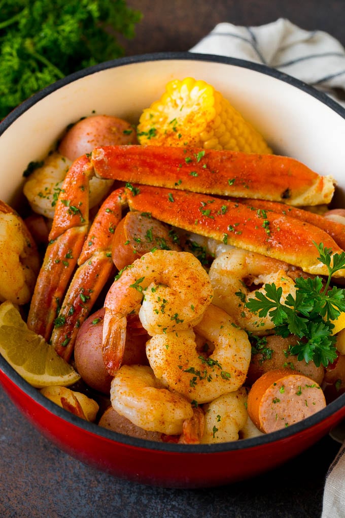 This Low Country Boil is a blend of shrimp, crab, sausage, corn and potatoes, all cooked together to create a hearty dinner. A pot of Low Country Boil with shrimp, crab and vegetables.