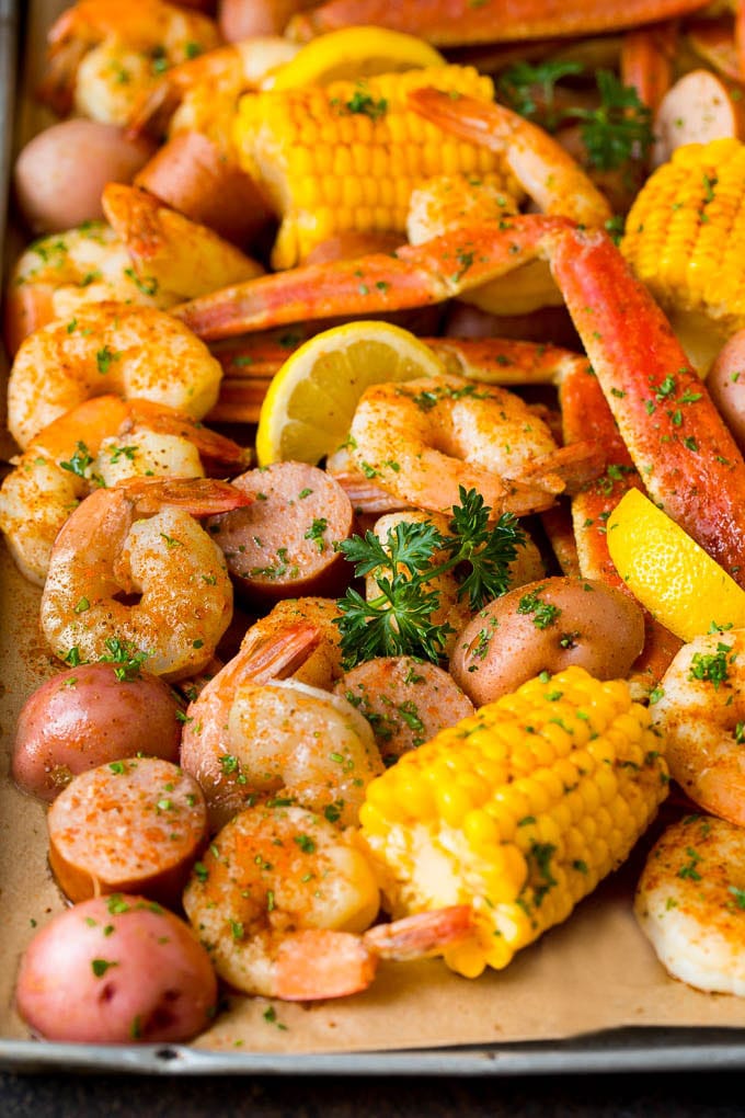 This Low Country Boil is a blend of shrimp, crab, sausage, corn and potatoes, all cooked together to create a hearty dinner. A Low Country Boil with shrimp, crab, sausage corn and potatoes on a sheet pan.