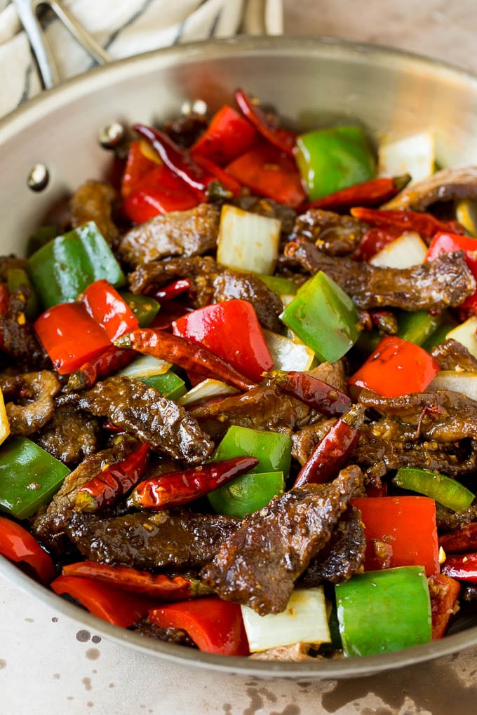 This Szechuan beef is a spicy stir fry made with tender pieces of beef and colorful vegetables, all tossed in a sweet and savory sauce. Szechuan beef with peppers, onions and spices.