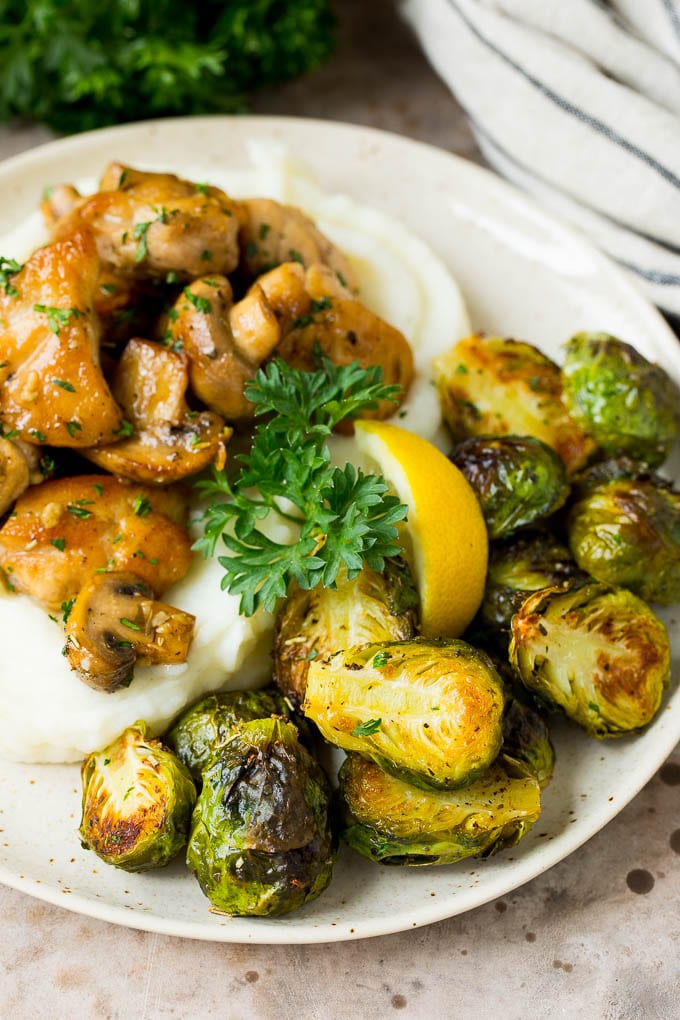 These crispy Brussels sprouts are coated in olive oil, garlic and seasonings, then roasted at high heat until tender and golden brown. Crispy Brussels sprouts served with mashed potatoes and garlic chicken.