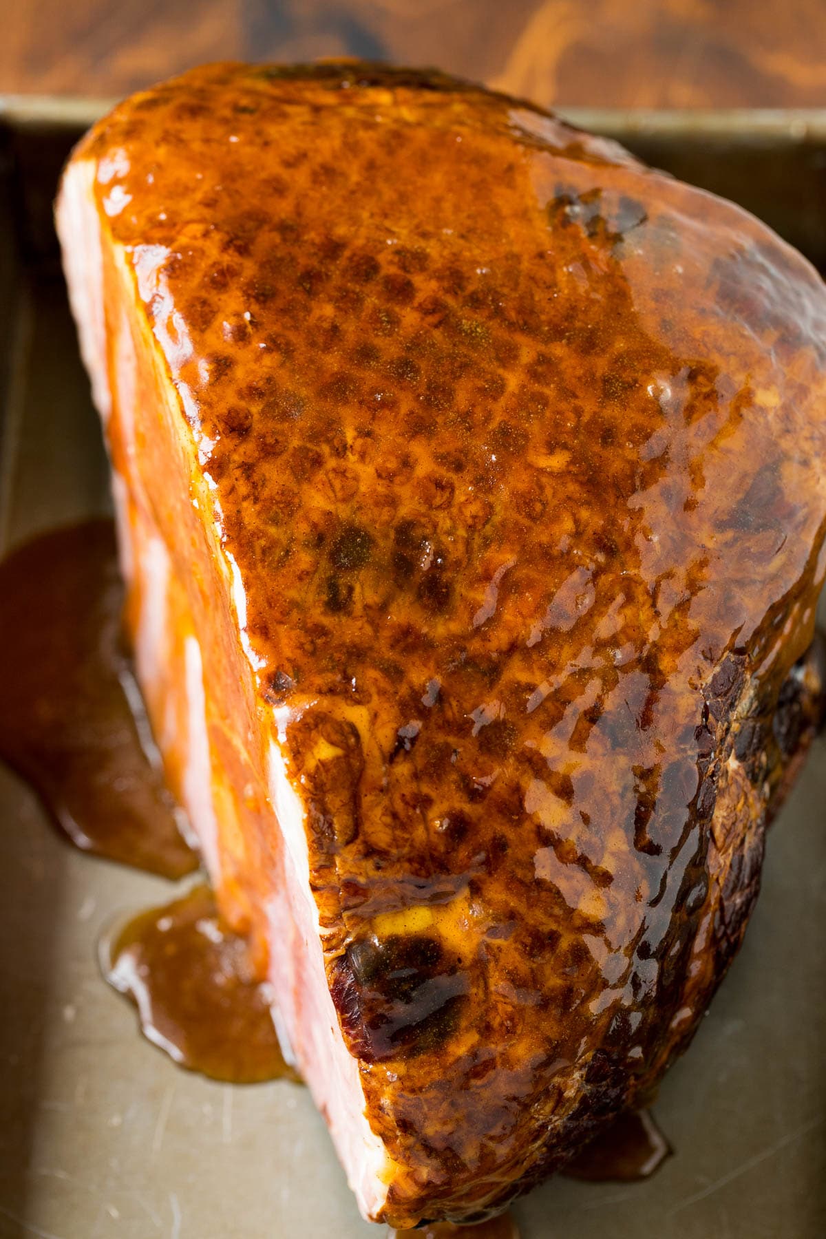 This ham glaze is a combination of butter, brown sugar, pineapple juice and spices, all simmered together until thickened. Pork coated and in a baking pan.