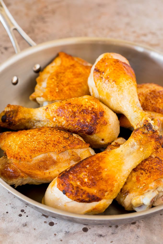 This chicken adobo is a Filipino dish made with chicken pieces simmered in a sweet and savory sauce. An easy dinner option with minimal ingredients that always gets rave reviews! Browned chicken pieces in a skillet.