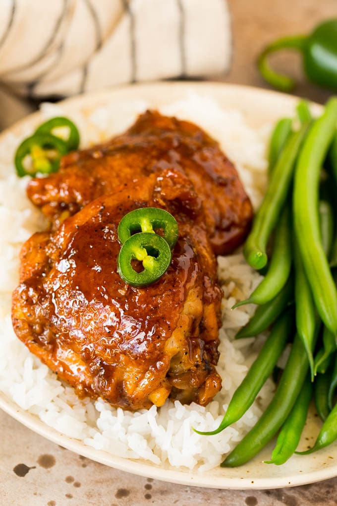 This chicken adobo is a Filipino dish made with chicken pieces simmered in a sweet and savory sauce. An easy dinner option with minimal ingredients that always gets rave reviews! Chicken adobo served with rice and green beans.