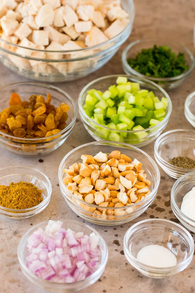 Bowls of ingredients including chicken, diced vegetables and spices.