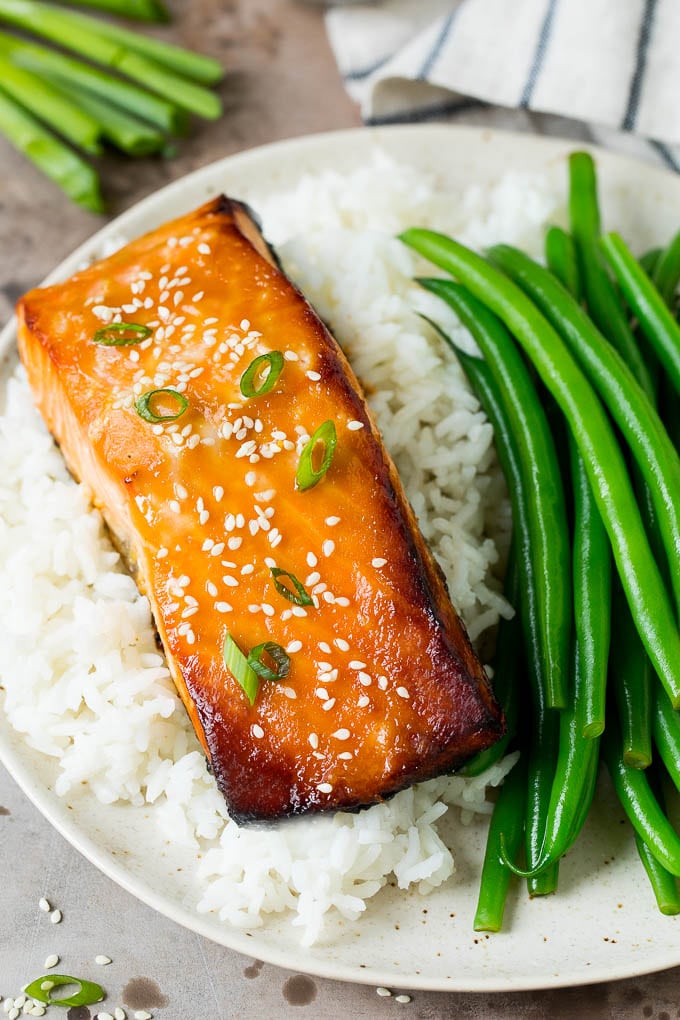 This miso salmon is fresh fish fillets soaked in a flavorful marinade, then broiled to perfection and topped with sesame seeds. Miso salmon served with rice and green beans.