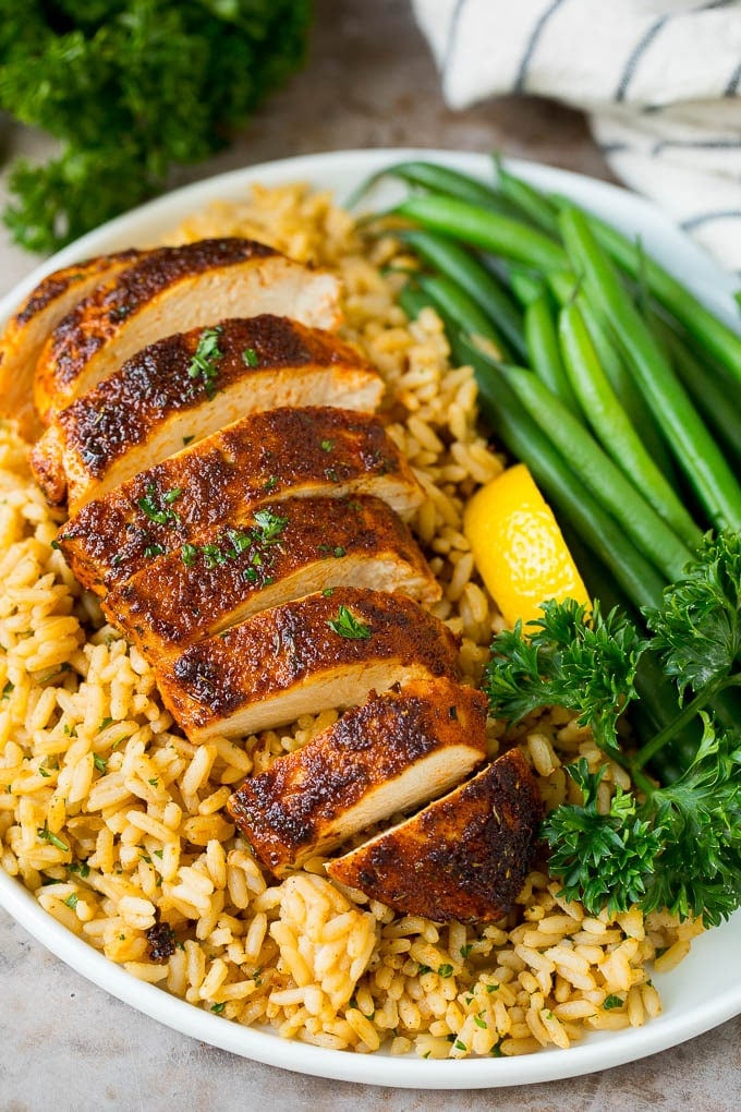 Sliced blackened chicken served over rice.