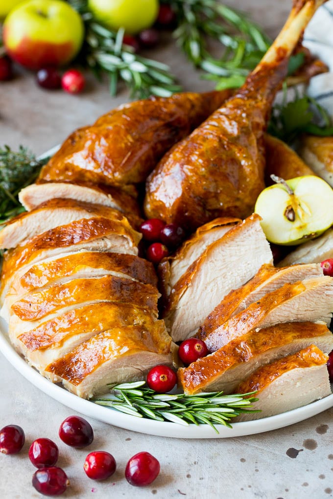 This is a complete guide on how to brine a turkey to get the most tender and flavorful bird each and every time. Sliced turkey on a serving plate.