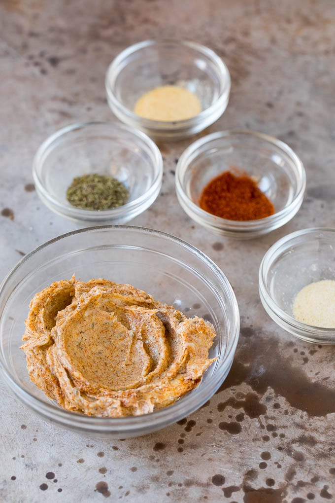 This Instant Pot turkey breast is seasoned with butter, garlic and herbs, then pressure cooked to tender and juicy perfection. Butter mixed with herbs and spices along with bowls of seasonings.