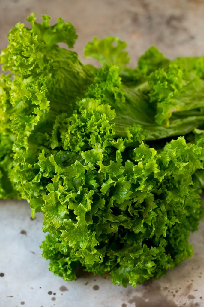 These Southern style mustard greens are cooked with smoky bacon and seasonings until tender and flavorful. A bunch of raw mustard leaves.