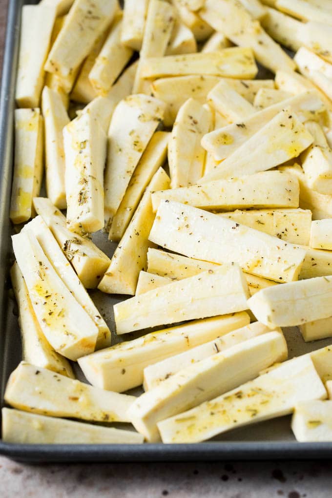 These roasted parsnips are coated in garlic, olive oil and herbs, then cooked in the oven until golden brown and tender. A quick and easy side dish option that pairs perfectly with chicken, beef and pork. Root vegetables coated in olive oil, herbs and garlic.