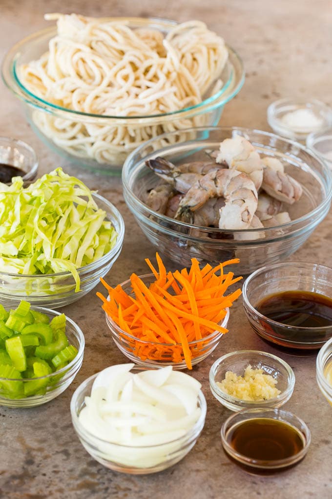 This shrimp lo mein is succulent shrimp with vegetables and egg noodles, all tossed together in a savory sauce. Bowls of ingredients including shrimp, noodles and vegetables.