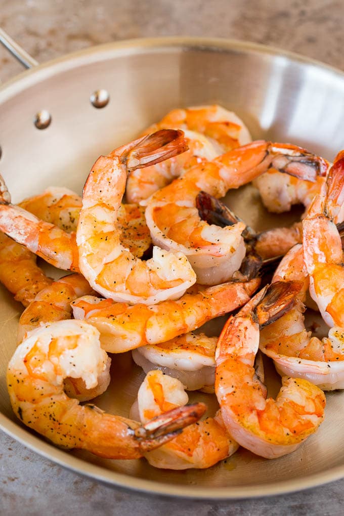 This shrimp lo mein is succulent shrimp with vegetables and egg noodles, all tossed together in a savory sauce. Cooked shrimp in a pan.