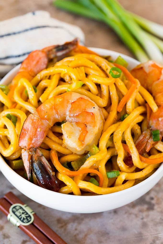 This shrimp lo mein is succulent shrimp with vegetables and egg noodles, all tossed together in a savory sauce. A bowl of shrimp lo mein.