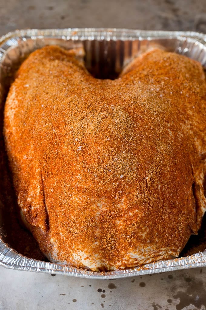 This smoked turkey breast is soaked in brine, then coated in homemade spice rub and cooked on a smoker until it is tender and juicy. Poultry coated in homemade spice rub.